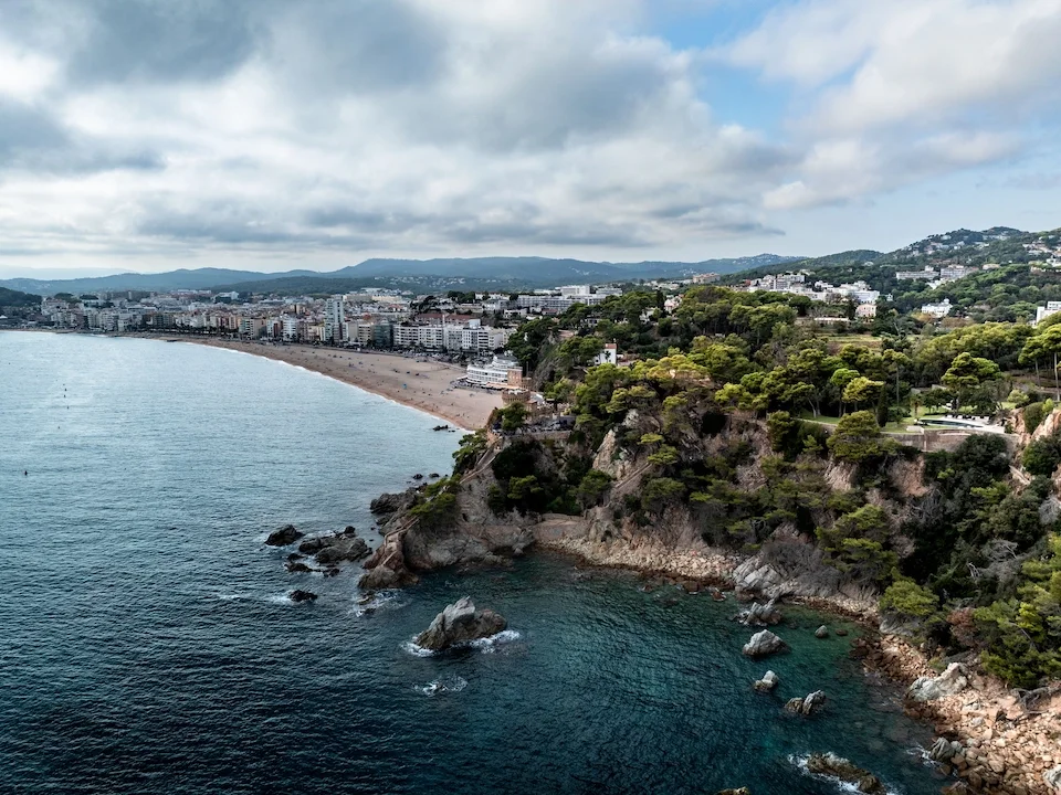 The Costa del Sol coastline seen from above, with cliffs, pine slopes and the Mediterranean.